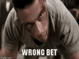 a man is laying on the floor with the words wrong bet written on his chest .