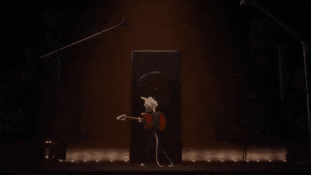 a cat is playing a guitar in front of a microphone