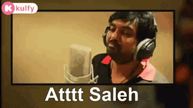 a man wearing headphones singing into a microphone with the name atttt saleh on the bottom right