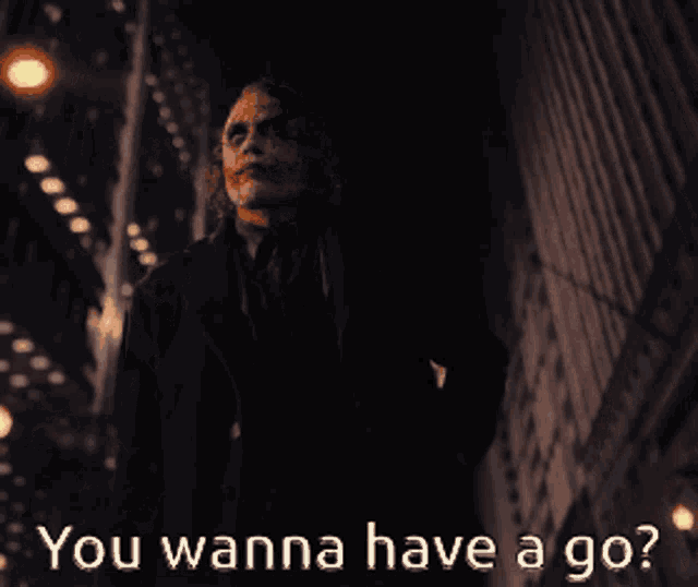 a picture of the joker with the words " you wanna have a go " below him