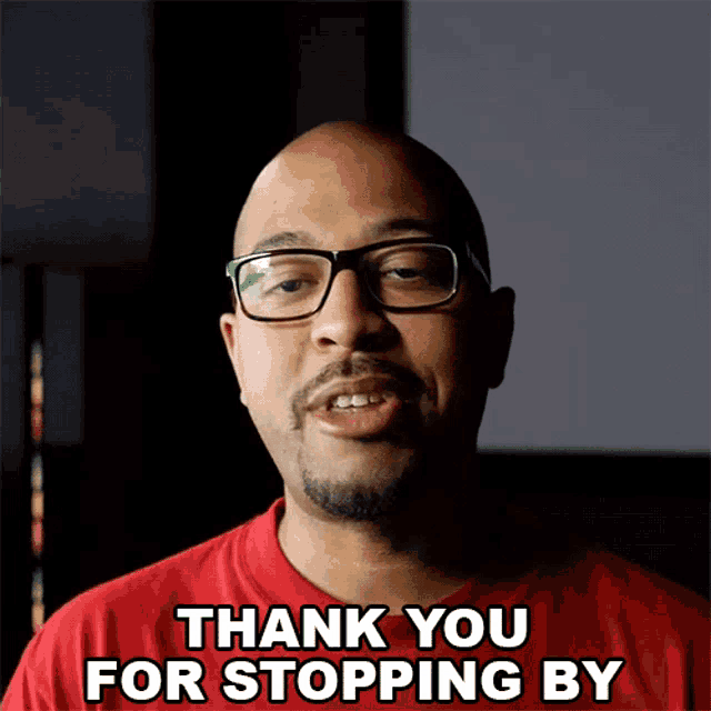 a man with glasses and a red shirt says thank you for stopping by