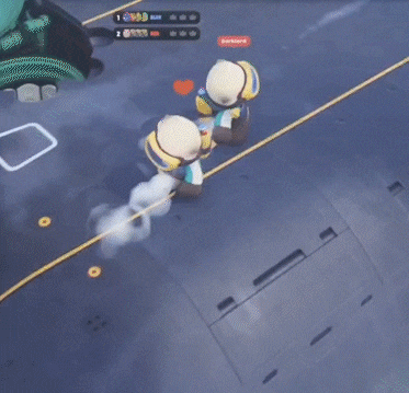 two teddy bears are playing a video game and one of them has a heart on his chest