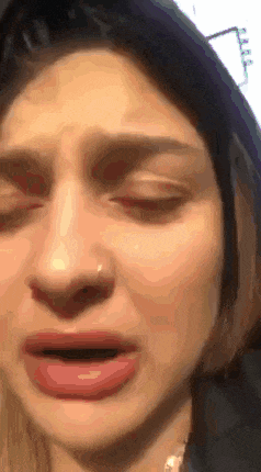 a close up of a woman with her eyes closed
