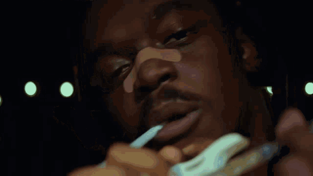 a close up of a man brushing his teeth with a toothbrush .