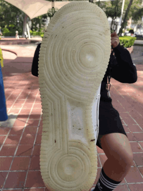 the bottom of a person 's shoe has a circle on it