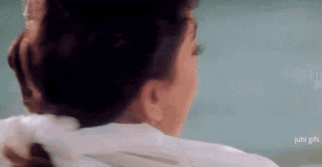 a close up of a woman 's ear and neck in a movie .