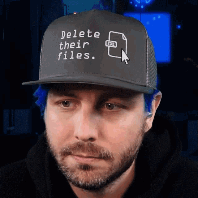 a man is wearing a hat that says delete their files
