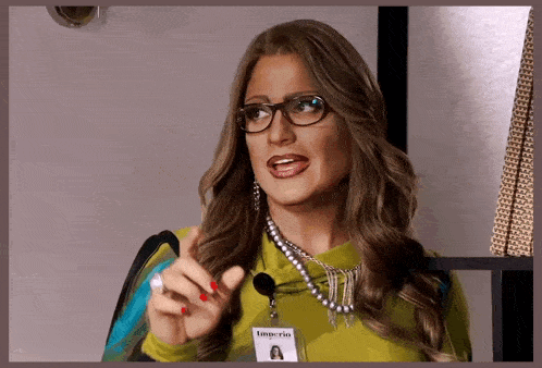 a woman wearing glasses and a name tag with imperio on it