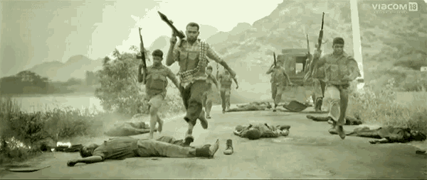 a group of soldiers running down a road with a sign that says viacom on it