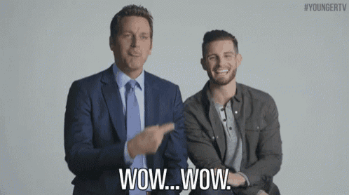 two men in suits and ties are standing next to each other and one of them is saying wow wow .