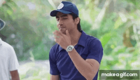 a man wearing a blue shirt and a blue hat has a make a gif.com button below him