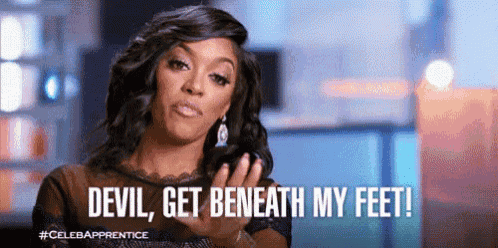 a woman is making a funny face and says devil , get beneath my feet !