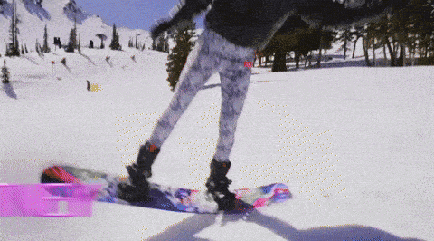 a person is snowboarding down a snow covered hill
