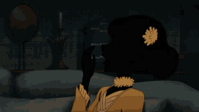 a silhouette of a woman sitting on a couch with a flower in her hair