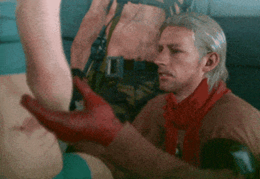 a man in a red scarf holds a woman 's hand