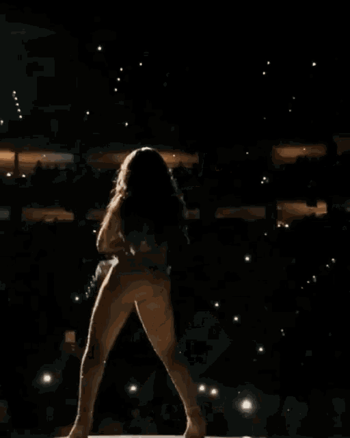 a naked woman is dancing on a stage in front of an audience