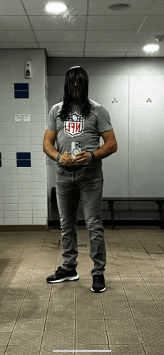 a man wearing a t-shirt with the nfl logo on it