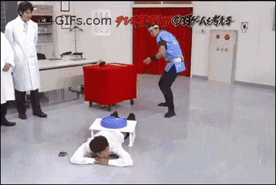 a man is laying on the floor in front of a sign that says gifs.com ..