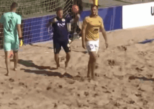 a group of men are playing a game of volleyball on a beach .