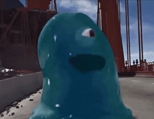 a blue monster with a big eye is standing in front of a red bridge