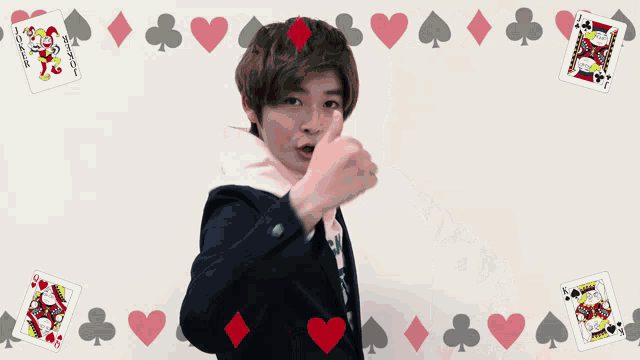 a girl stands in front of playing cards including the joker