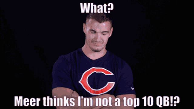 a man wearing a chicago bears t-shirt with his arms crossed