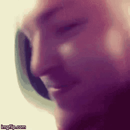 a close up of a man 's face wearing headphones
