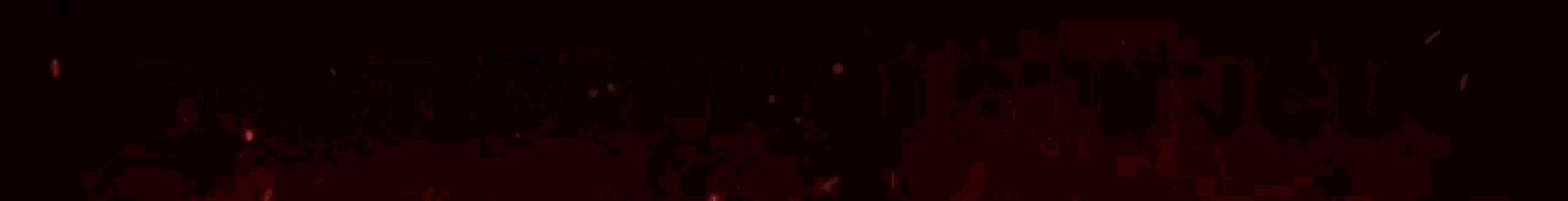 a close up of a red light coming out of a hole in a dark room .