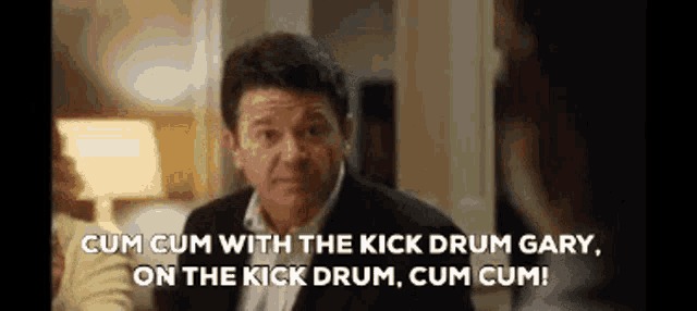 a man in a suit is saying cum cum with the kick drum gary , on the kick drum , cum cum !