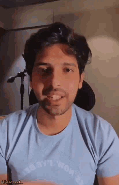 a man wearing a light blue t-shirt that says ' i 'm not a robot '