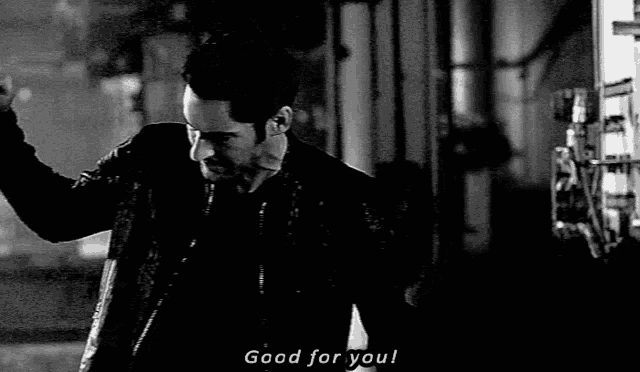 a man in a black jacket says good for you in a black and white photo