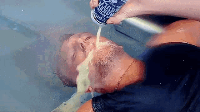 a man is drinking from a can of king fruit