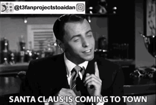 a man in a suit and tie is talking about santa claus coming to town