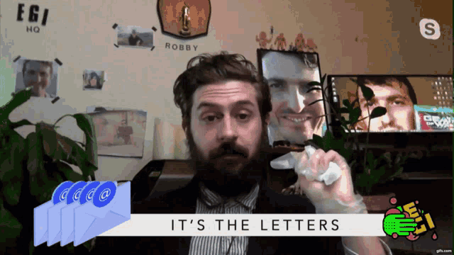 a man with a beard is holding a piece of paper with the words it 's the letters on it