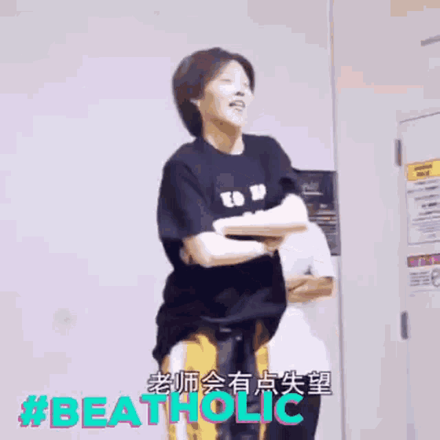 a woman in a black shirt is dancing in a room with chinese writing on it .