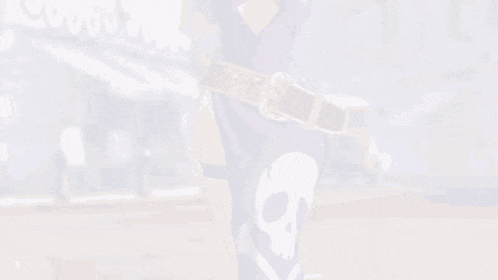 a woman in a purple dress is standing in front of a building with her arms outstretched .