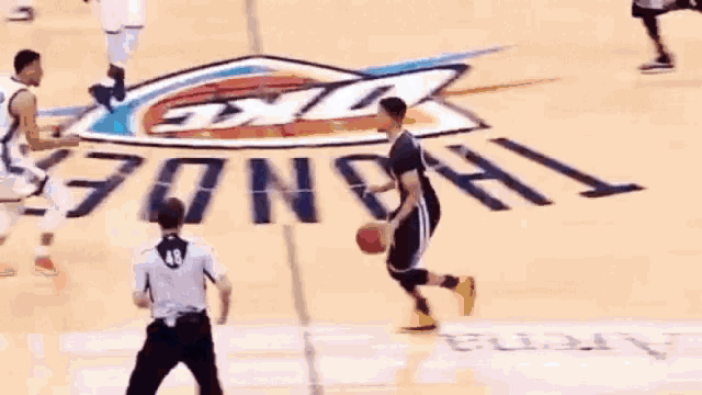 a basketball game is being played on a court that has the thunder logo on it