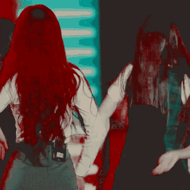 a woman with red hair is wearing a tie