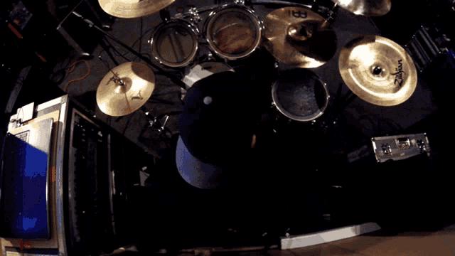 a person playing a drum set with zildjian cymbals on the floor