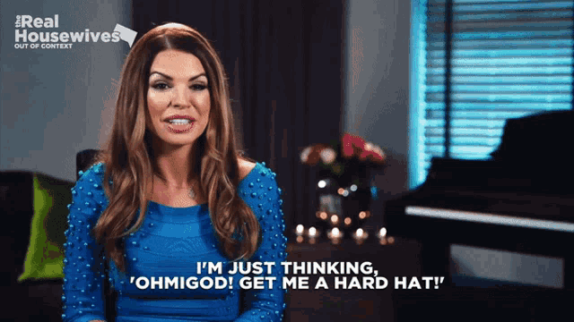 a woman in a blue dress says " i 'm just thinking "