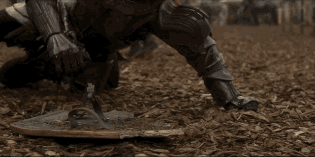 a group of soldiers are kneeling down in the dirt