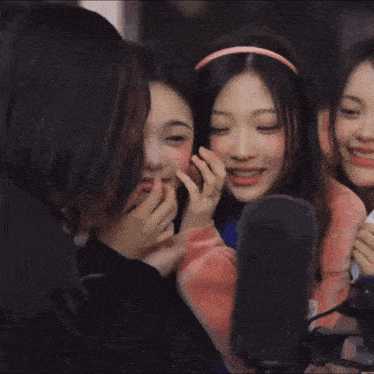 a group of girls with korean writing on the bottom