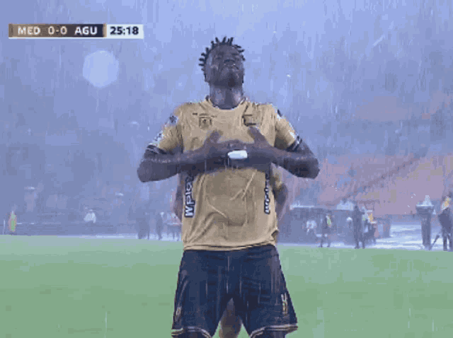 two soccer players are celebrating a goal during a game between med and agui