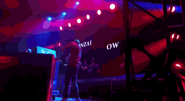 a man stands on a stage in front of a large screen that says gonzalez on it