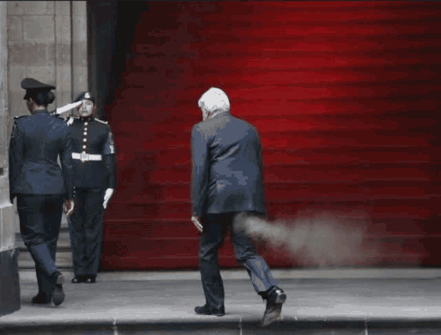 a man in a suit is walking down a set of stairs