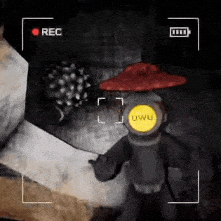 a video game character wearing a red hat and a backpack is being recorded .
