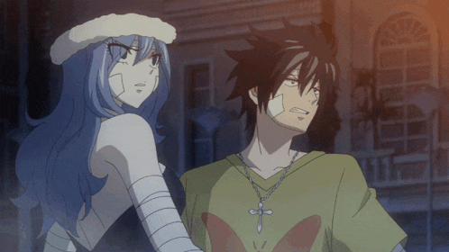 a man with a cross necklace stands next to a woman with bandages on her face