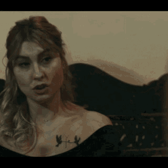 a woman with a tattoo on her shoulder that says freedom