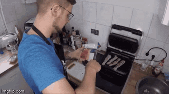 a man in a blue shirt is cooking in a kitchen with imgflip.com written on the bottom