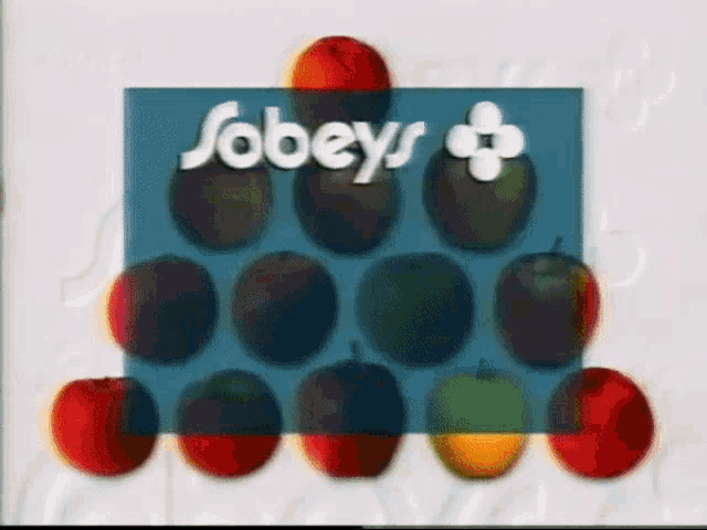 some apples are stacked on top of each other in front of a sobeys logo